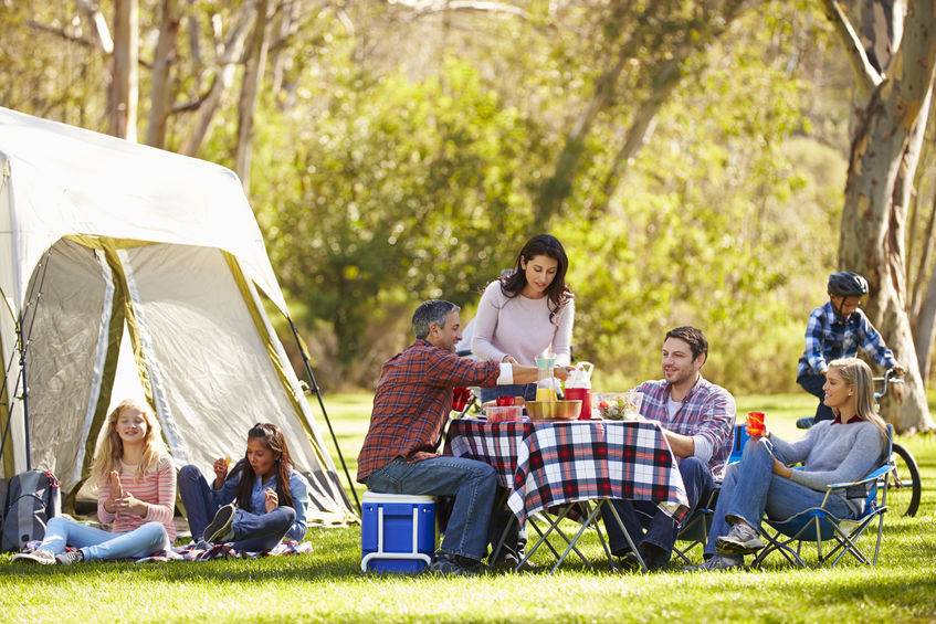 wo families enjoying camping holiday in countryside